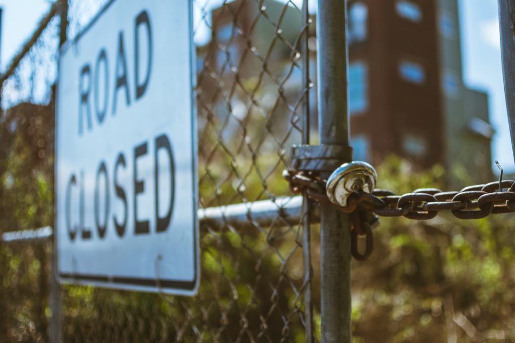 chained gate fence road closed sign