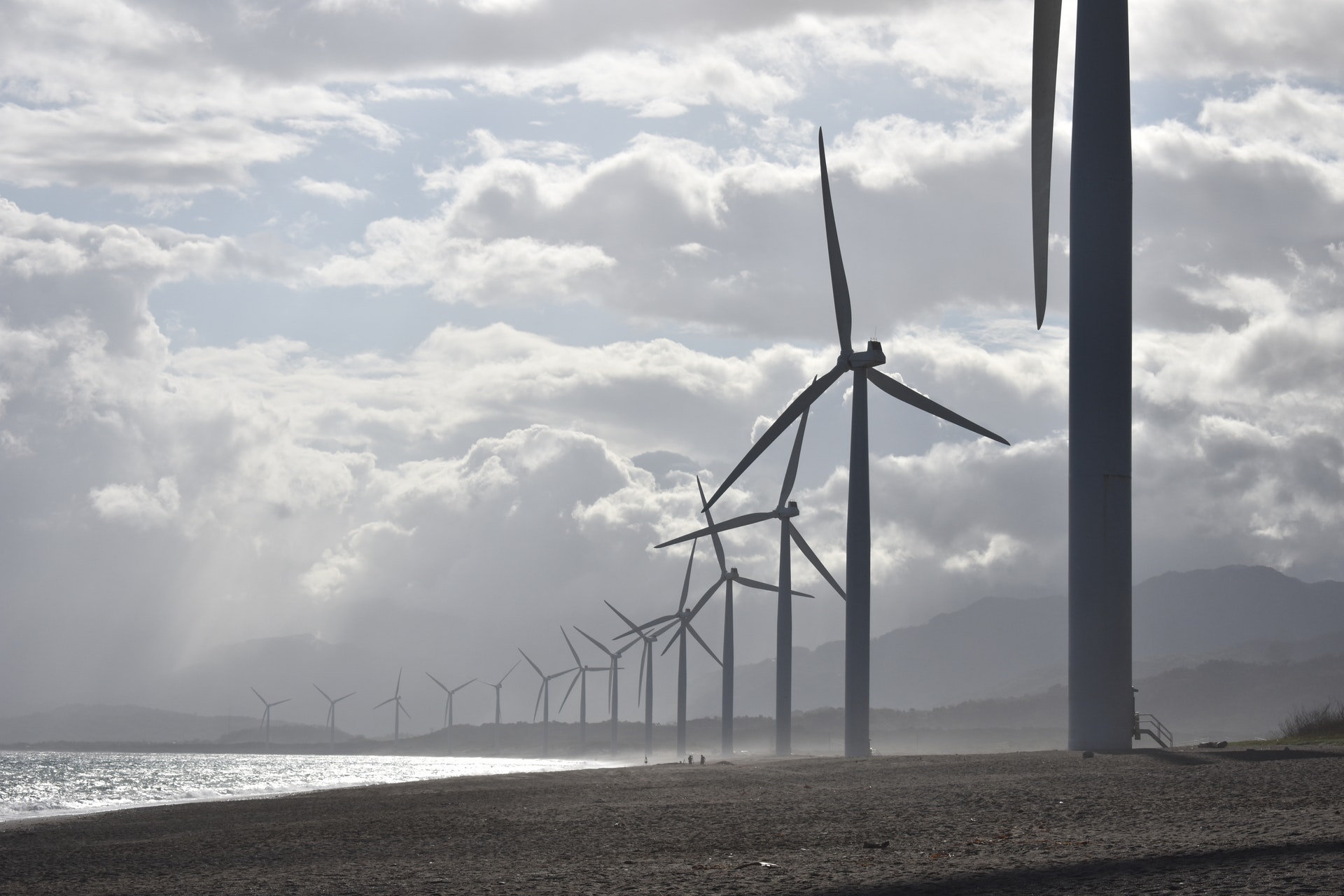 A line of wind turbines along a cost