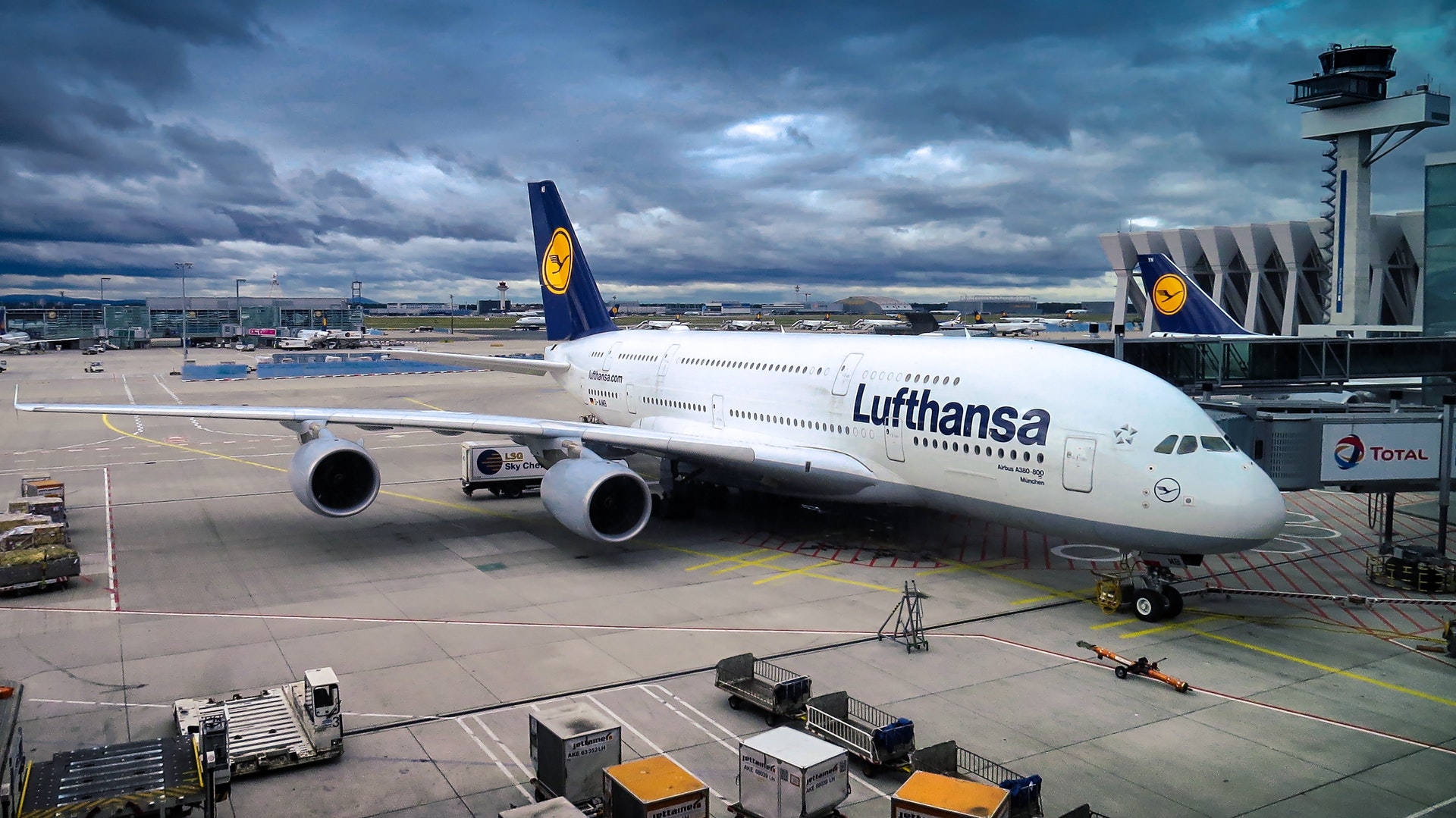 A parked Lufthansa air plane on a cloudy day