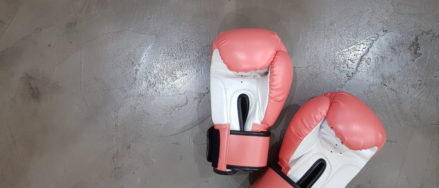 boxing gloves A pair of pink and white boxing gloves on a grey floor