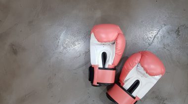 boxing gloves A pair of pink and white boxing gloves on a grey floor