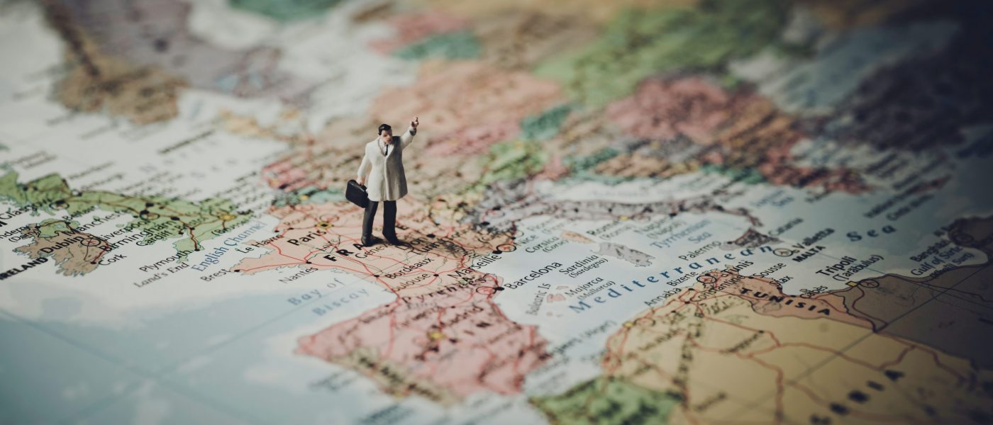 Small figure standing on map