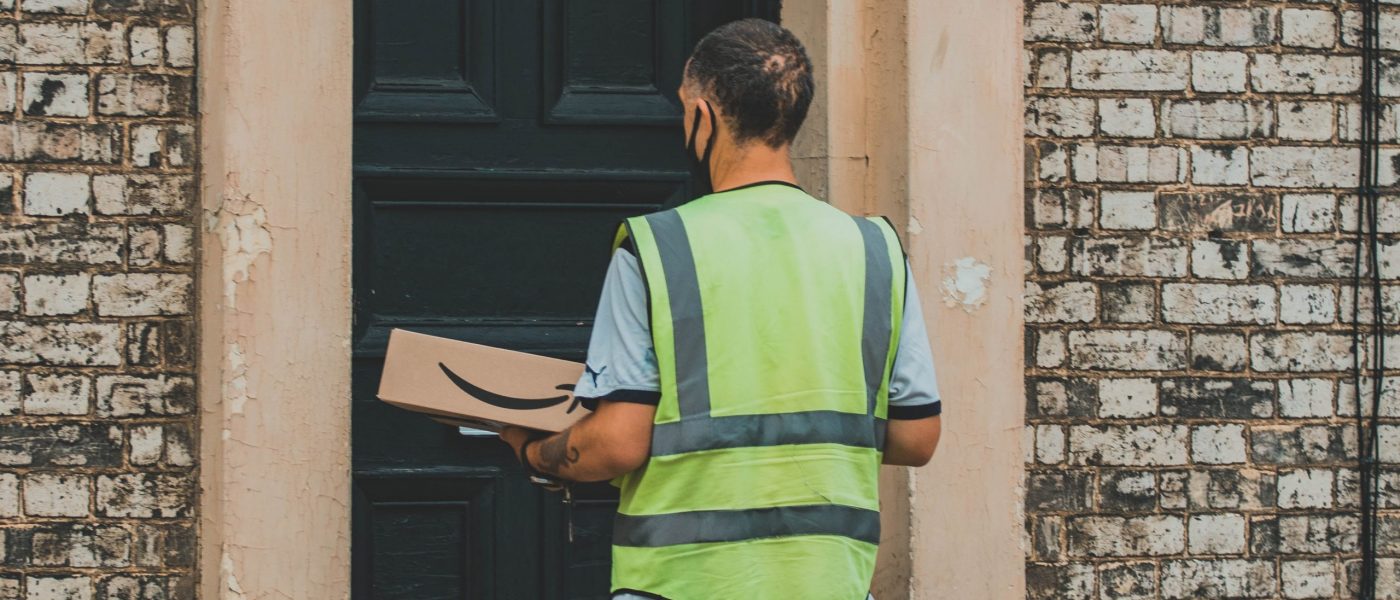 A man delivers an Amazon package A man delivers an Amazon package