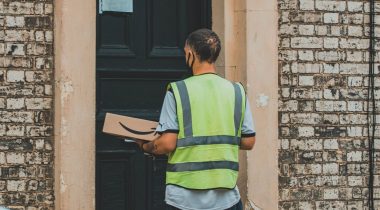 A man delivers an Amazon package A man delivers an Amazon package