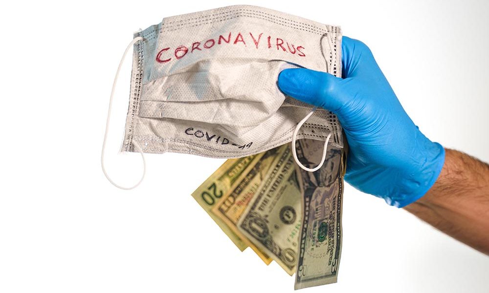 Hand,With,Dollar,Bills,And,A,Face,Mask,With,The