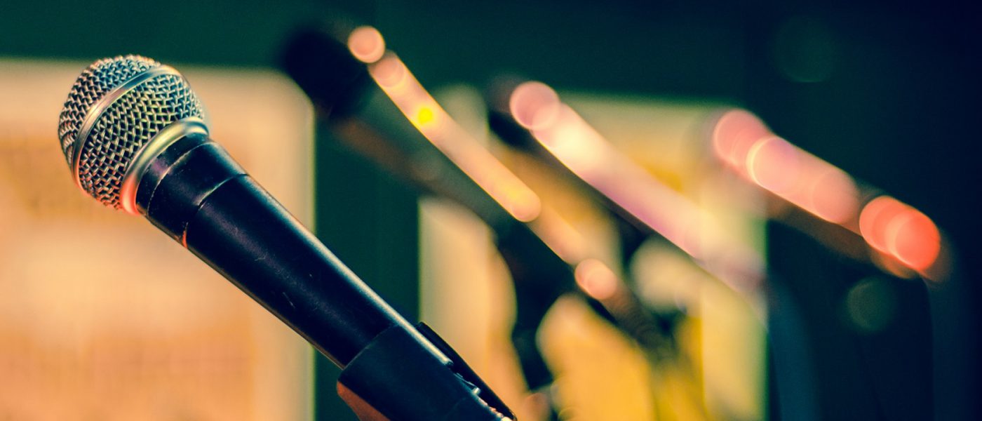 microphones_banner a row of microphones on a stage