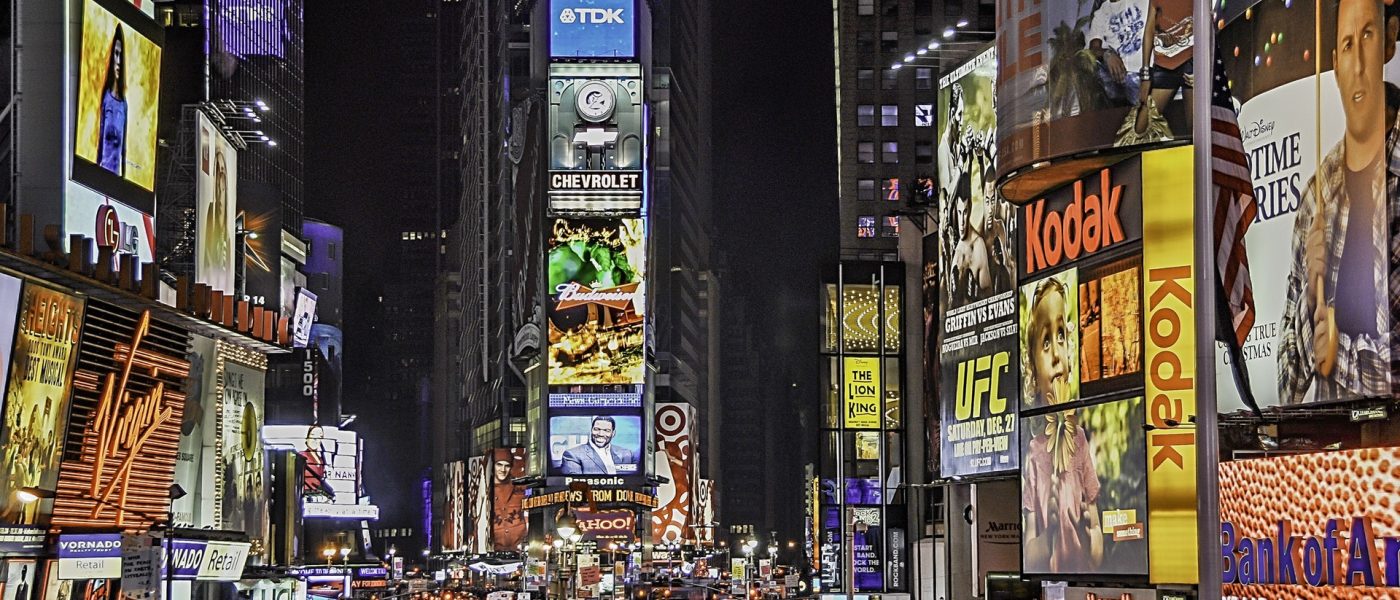 times square new york New York Times square at night, brightly lit and busy.