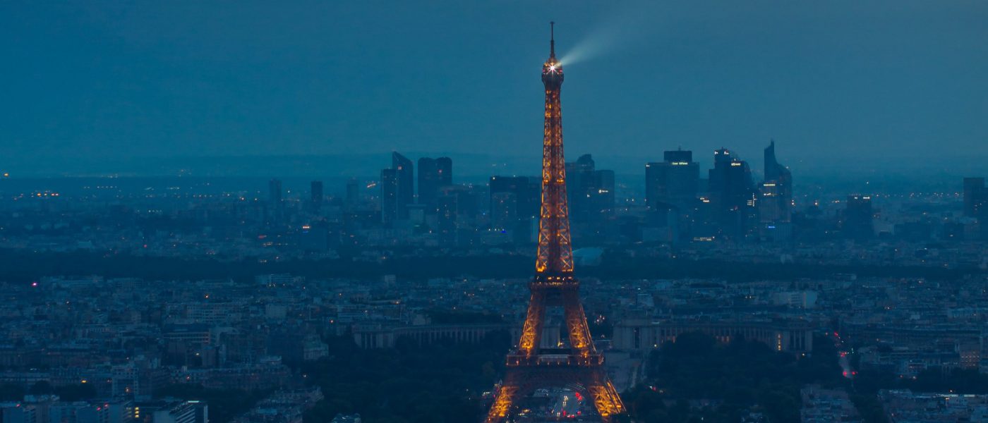Eiffel Tower spotlight against a stormy evening sky-cropped Eiffel Tower spotlight against a stormy evening sky