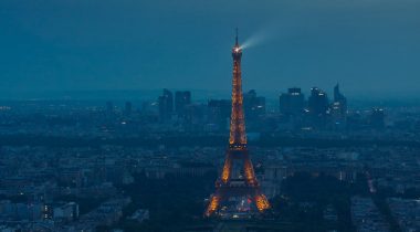 Eiffel Tower spotlight against a stormy evening sky-cropped Eiffel Tower spotlight against a stormy evening sky