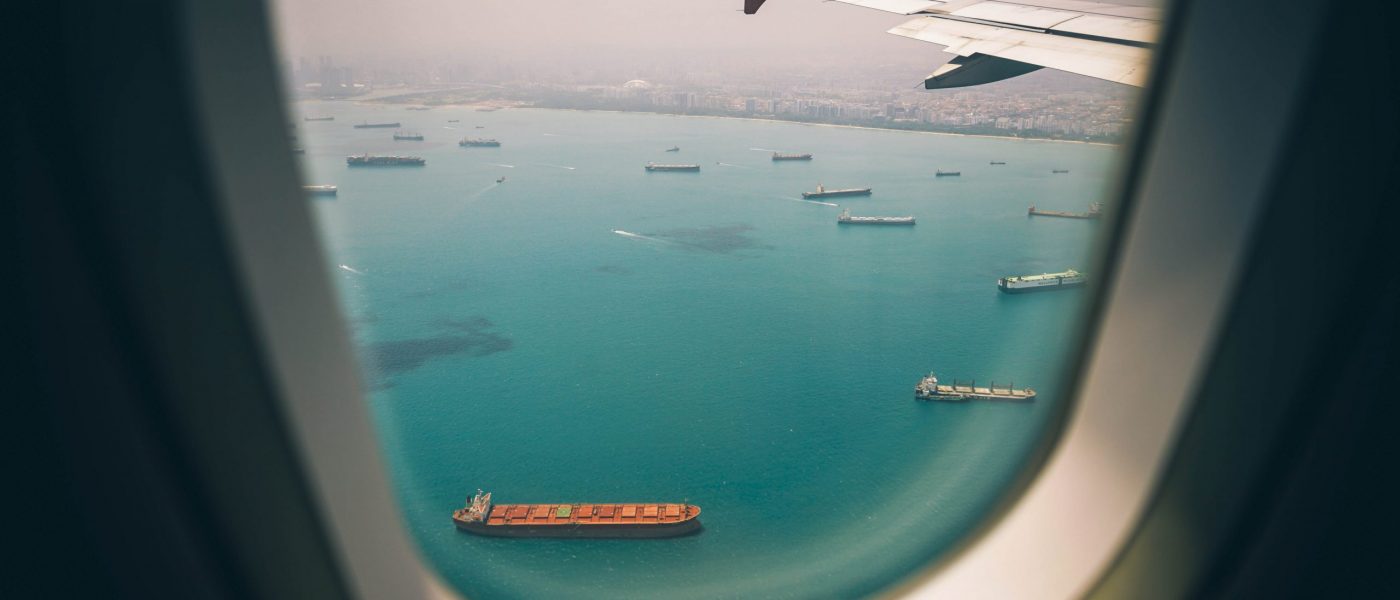 View of port and cargo ships from airplane window View of port and cargo ships from airplane window