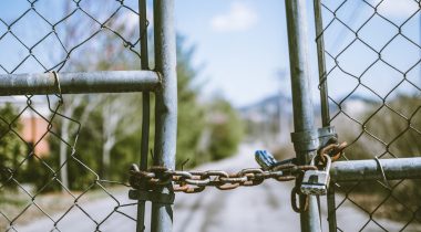 fence-in-shallow-photography Chain locked fence