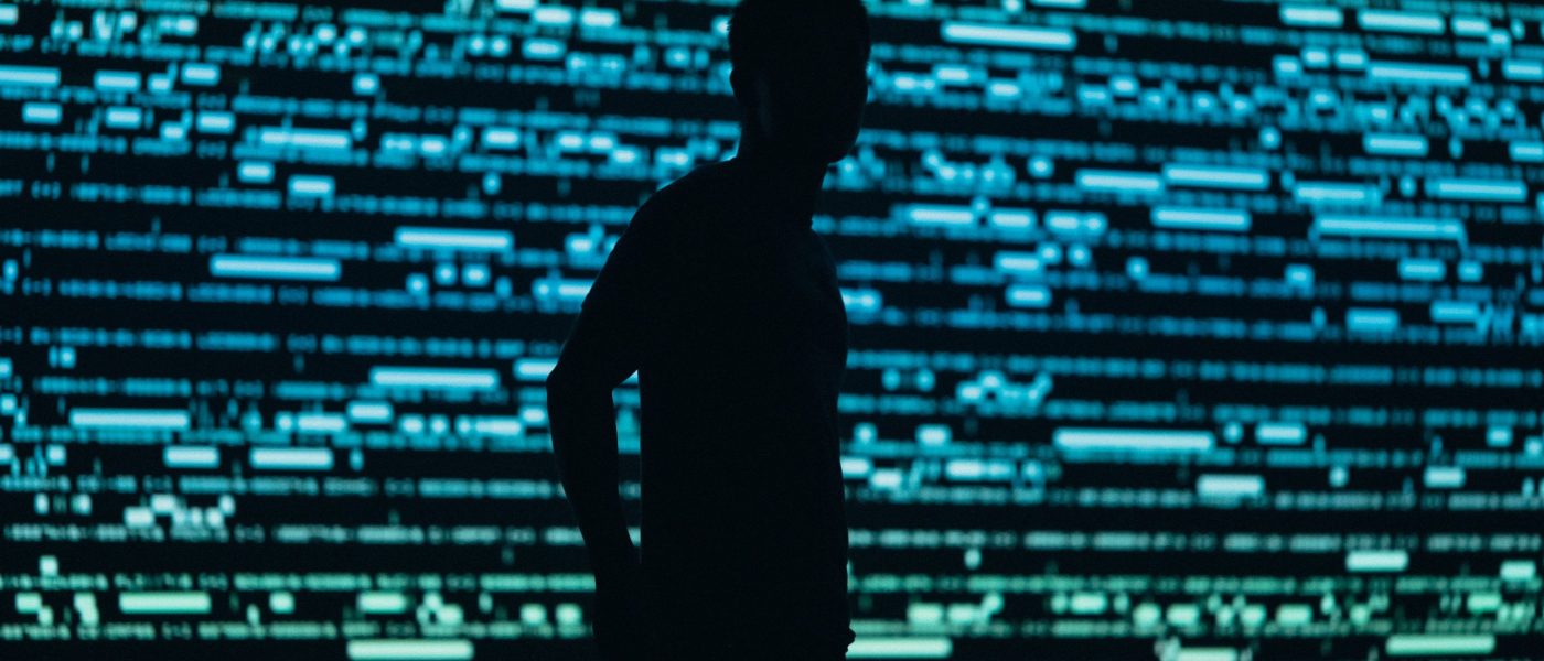 Silhouette of a person in front of panel lights Silhouette of a person in front of panel lights