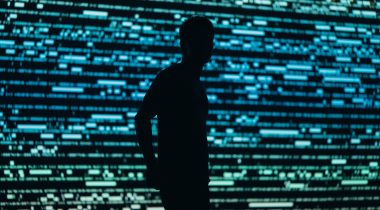 Silhouette of a person in front of panel lights Silhouette of a person in front of panel lights