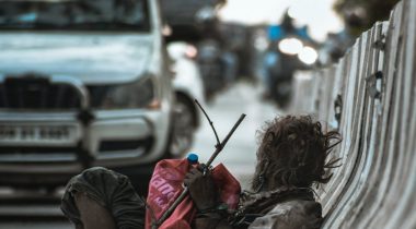 man-sitting-at-the-side-of-the-road-leaning-back-on-road-3107799