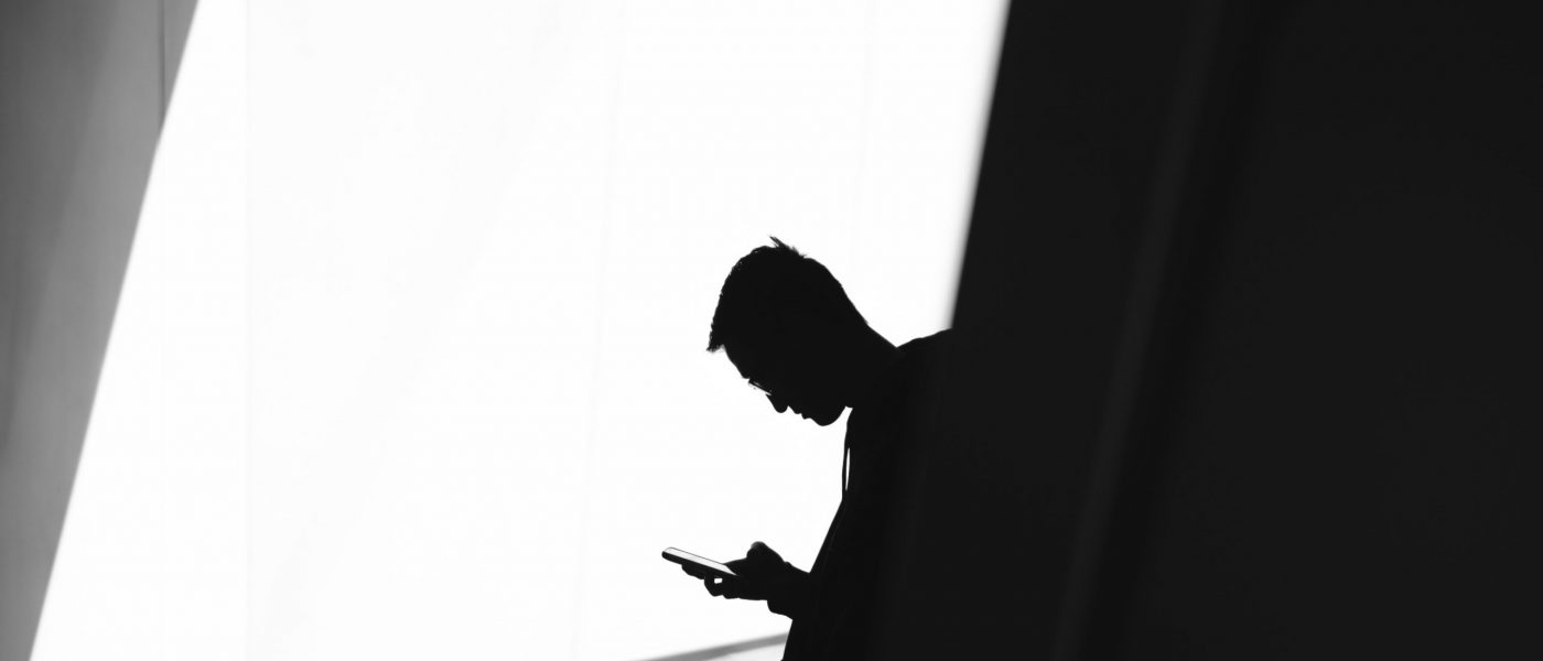 man-on-phone-light-shadow-secrecy