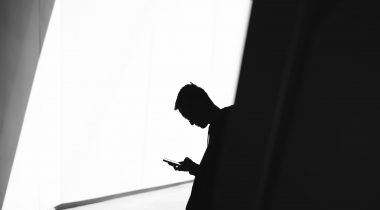man-on-phone-light-shadow-secrecy