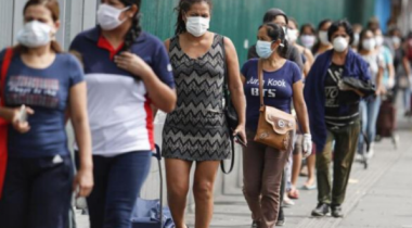 Women queuing in a line wearing face masks Women queuing in a line wearing face masks